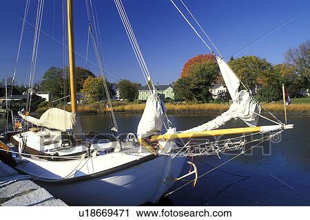 Stock Image -  sailboat, Wickford, Rhode Island, RI, Sailboat moored on a dock on Narragansett Bay in Wickford in the fall.. Fotosearch