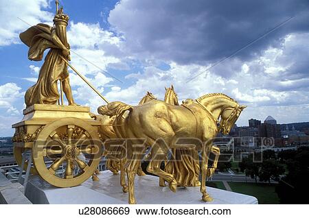 Saint Paul, State Capitol, State House, MN, Minnesota, Twin Cities, The Progress of the State a gilded four horse chariot sculpture adorns the base of the dome of The Minnesota State Capitol Building in the Capital City of St. Paul. View Large Photo Image Stock Photo - Saint Paul, State Capitol, State House, MN, Minnesota, Twin Cities, The Progress of the State a gilded four horse chariot sculpture adorns the base of the dome of The Minnesota State Capitol Building in the Capital City of St. Paul. . Fotosearch