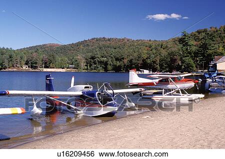 Stock Photograph -  seaplane, Adirondacks, New York, NY, Long Lake, Seaplanes along the beach at Long Lake in the Adirondack Mountains.. Fotosearch