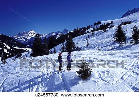 ski resort, snowshoeing, Alps, Switzerland, Valais, Les Crosets, Portes du Soleil, Swiss Alps, Europe, Mother and daughter snowshoeing in the Portes du Soleil ski resort the largest international and linked ski resort in the world in the Swiss Alps. View Large Photo Image Stock Image - ski resort, snowshoeing, Alps, Switzerland, Valais, Les Crosets, Portes du Soleil, Swiss Alps, Europe, Mother and daughter snowshoeing in the Portes du Soleil ski resort the largest international and linked ski resort in the world in the Swiss Alps.. Fotosearch