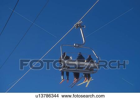skiing, ski lift, winter, Warren, VT, Vermont, Skiers riding on quad chair lift at Sugarbush Ski Resort in Warren in winter. View Large Photo Image Picture - skiing, ski lift, winter, Warren, VT, Vermont, Skiers riding on quad chair lift at Sugarbush Ski Resort in Warren in winter.. Fotosearch