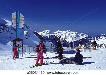 Stock Image -  skiing, Switzerland, Valais, Les Crosets, Portes du Soleil, Swiss Alps, Europe, People skiing and snowboarding in Portes du Soleil, the largest international and linked ski area in the world, in the Swiss Alps on the French/Swiss border. . Fotosearch