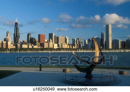 Stock Photo -  skyline, Chicago, Illinois, IL, Lake Michigan, Downtown skyline of Chicago and Chicago Harbor on Lake Michigan from Adler Planetarium. Sundial in foreground.. Fotosearch