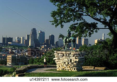 Stock Image -  skyline, Kansas City, MO, Missouri, A bronze statue of Indian Scout overlooks the downtown skyline of Kansas City from Penn Valley Park.. Fotosearch