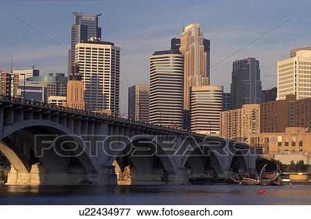 Stock Photo -  skyline, Minneapolis, MN, Minnesota, Twin Cities, Downtown skyline of Minneapolis, 3rd Avenue Bridge crosses the Mississippi River. . Fotosearch