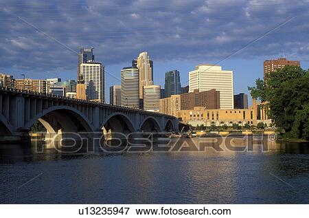 Stock Photo -  skyline, Minnesota, Minneapolis, MN, Twin Cities, Downtown skyline of Minneapolis, 3rd Avenue Bridge crosses the Mississippi River. . Fotosearch