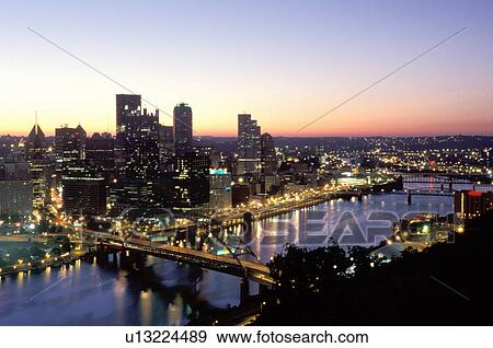 Stock Photo -  skyline, Pittsburgh, PA, Pennsylvania, aerial view of the downtown skyline of Pittsburgh illuminated at sunrise along the Monongahela River.. Fotosearch