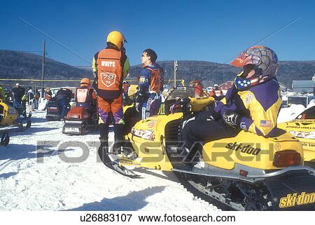 Stock Photo -  snowmobile, winter, Waitsfield, VT, Vermont, Participants waiting for the Snowmobile Race to start at the Mad River Valley Winter Carnival in Waitsfield in winter.. Fotosearch