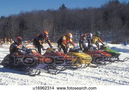 snowmobiling, winter, Waitsfield, VT, Vermont, Drivers lined up with their snowmobiles starting their engines to begin the Snowmobile Race at the Mad River Valley Winter Carnival in Waitsfield in winter. View Large Photo Image Picture - snowmobiling, winter, Waitsfield, VT, Vermont, Drivers lined up with their snowmobiles starting their engines to begin the Snowmobile Race at the Mad River Valley Winter Carnival in Waitsfield in winter.. Fotosearch