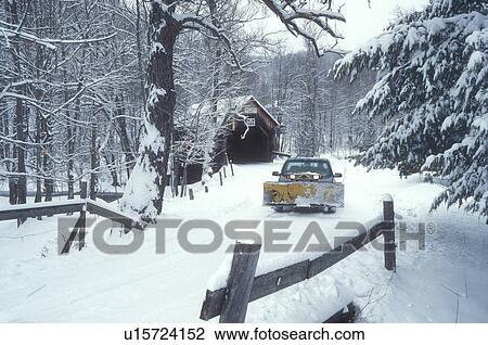 Stock Image -  snowplow, covered bridge, winter, Vermont, VT, Plowing the country road near Moxley Covered Bridge ca. 1883in the snow in winter in Chelsea.. Fotosearch