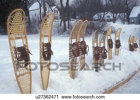 Stock Image -  snowshoes, winter, Brookfield, VT, Vermont, Snowshoe demonstration at the Ice Harvest Festival on the frozen Sunset Lake in Brookfield in winter.. Fotosearch
