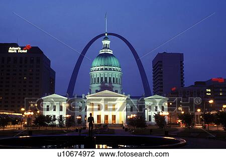 Stock Image -  St. Louis, downtown skyline, MO, Missouri, View of the Old Courthouse and Gateway Arch from Kiener Plaza in downtown Saint Louis in the evening. Jefferson National Expansion Memorial.. Fotosearch