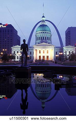 Stock Image -  St. Louis, MO, Missouri, Reflection of the Old Courthouse and Gateway Arch in the pond at Kiener Plaza in downtown Saint Louis in the evening. Jefferson National Expansion Memorial.. Fotosearch