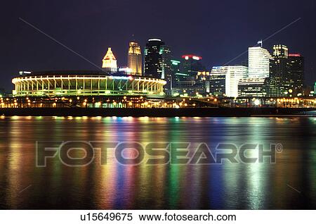 stadium, Cincinnati, skyline, OH, Ohio, Cinergy Field, home of the Cincinnati Reds, and downtown skyline of Cincinnati across the Ohio River in the evening.  View Large Photo Image Stock Photography -  stadium, Cincinnati, skyline, OH, Ohio, Cinergy Field, home of the Cincinnati Reds, and downtown skyline of Cincinnati across the Ohio River in the evening. . Fotosearch