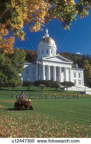 Stock Image -  State Capitol, capitol, State House, fall, Montpelier, VT, Vermont, Man mowing the lawn on the State House grounds in Montpelier in the autumn.. Fotosearch