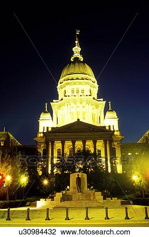 Stock Image -  State Capitol, Statehouse, Capitol, Springfield, IL, Illinois, The Illinois State Capitol building is illuminated in the evening in the capital city of Springfield, Illinois. . Fotosearch