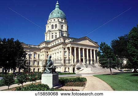 Stock Photo -  State Capitol, Topeka, State House, KS, Kansas, Statue of Pioneer Mother outside the State Capitol building in Topeka. The capitol, a French Renaissance style building.. Fotosearch