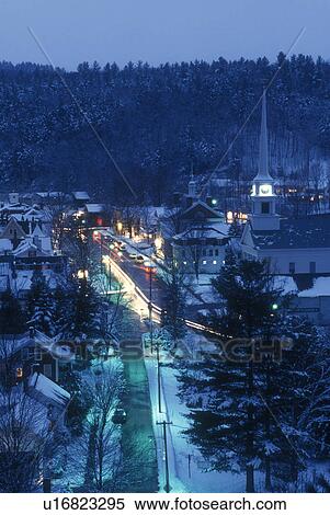 Stock Photography -  Stowe, aerial, ski resort, evening, village, holiday, snow, winter, Vermont, A scenic aerial view of the village of Stowe on a wintry night in Lamoille County in the state of Vermont. . Fotosearch
