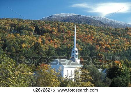 Stock Photography -  Stowe, church, fall, village, VT, Vermont, Scenic view of the Community Church in the village of Stowe and the first snow on the mountains surrounded by colorful fall foliage in autumn. . Fotosearch