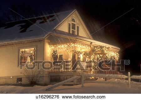 Stock Photograph -  Stowe, gift shop, snow, ski resort, evening, holiday, decorations, Christmas, winter, Vermont, A boutique is decorated for the Christmas holiday season in Stowe Village on a snow covered night in Lamoille County in the state of Vermont. . Fotosearch