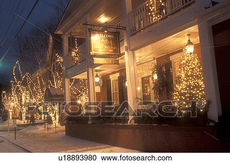 Stock Image -  Stowe, Inn, country inn, resort, hotel, ski resort, Christmas, holiday, decorations, resort, evening, snow, winter, Vermont, The Green Mountain Inn is decorated for the Christmas holiday season in the village of Stowe on a snow covered night in Lamoille . Fotosearch
