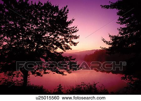 Stock Image -  sunrise, North Carolina, NC, Colorful sunrise with mist on Price Lake at Julian Price Memorial Park. . Fotosearch