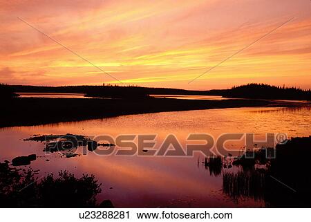 Stock Image -  sunrise, sunset, Newfoundland, NF, Canada, Sunset at Milan Arm in St. Anthony.. Fotosearch