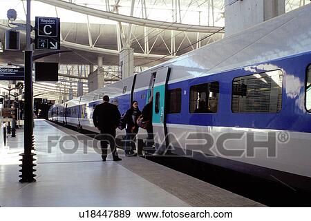 Stock Photo -  TGV, train, Paris, Charles de Gaulle, airport, France, Europe, Passengers boarding the TGV high-speed train at the TGV Train Station at the Roissy/Charles de Gaulle Airport. . Fotosearch