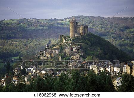 Stock Photo -  the Dordogne, France, Quercy, Midi-Pyrenees, Najac, Aveyron, Europe, A castle sits on top of the scenic medieval hilltop village of Najac.. Fotosearch
