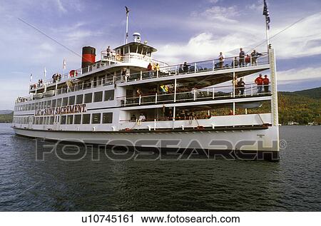 Stock Image -  tour boat, Lake George, Adirondacks, New York, NY, The Lac du Saint Sacrement paddlewheel cruise boat from the Lake George Steamboat Company on Lake George in the autumn.. Fotosearch