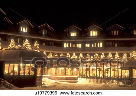 Stock Photograph -  Trapp Family, Lodge, resort, Stowe, inn, hotel, Vermont, Christmas, decorations, holiday, evening, winter, The Trapp Family Lodge in Stowe is elegantly decorated with white lights for the Christmas holiday season on a snow covered night in Stowe in Lamoi. Fotosearch