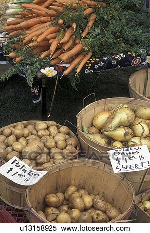 Stock Photography -  vegetables, outdoor market, produce, Vermont, VT, Onions, carrots, and potatoes for sale at the Farmers Market in Waterbury. . Fotosearch