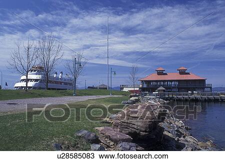 Stock Image -  Vermont, VT, Burlington, Community Boathouse and Ethan Allen Ferry on the Waterfront of Lake Champlain.. Fotosearch