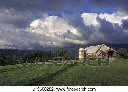 Stock Image -  Vermont, VT, Storm clouds over the Green Mountains and Bragg Farm in Fayston . Fotosearch