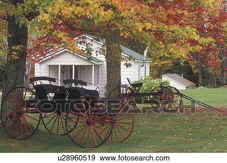 Stock Photo -  wagon, cottage, autumn, Westmore, VT, Vermont, Antique wagons display outside a country cottage in the fall.. Fotosearch