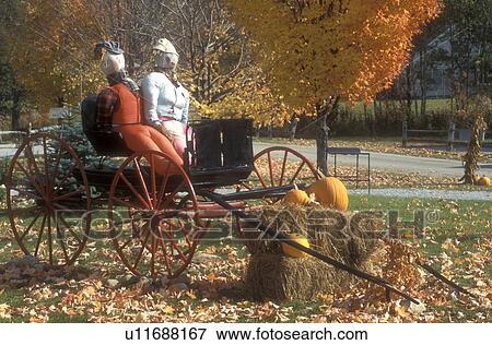 wagon, fall decoration, Weston, VT, Vermont, A scarecrow couple sit on top of a wagon as a fall decoration in Weston in autumn. View Large Photo Image Stock Photo - wagon, fall decoration, Weston, VT, Vermont, A scarecrow couple sit on top of a wagon as a fall decoration in Weston in autumn.. Fotosearch