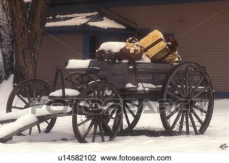 wagon, gifts, Christmas, decoration, holiday, snow, winter, A snow covered antique wagon full of presents is parked outside the Cold Hollow Cider Mill in Waterbury Center in Washington County in the state of Vermont. View Large Photo Image Stock Image - wagon, gifts, Christmas, decoration, holiday, snow, winter, A snow covered antique wagon full of presents is parked outside the Cold Hollow Cider Mill in Waterbury Center in Washington County in the state of Vermont. . Fotosearch
