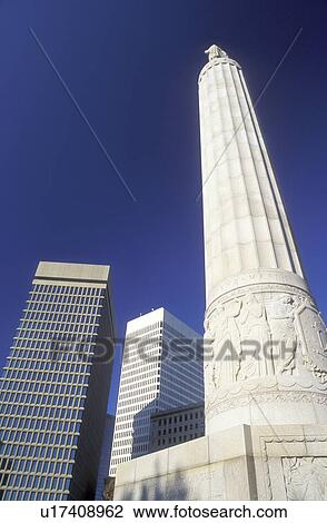 Stock Image -  war memorial, Providence, Rhode Island, RI, World War I Monument and high rise buildings in downtown Providence in the fall.. Fotosearch