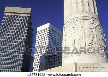 Stock Image -  war memorial, Providence, Rhode Island, RI, World War I Monument and high rise buildings in downtown Providence in the fall.. Fotosearch