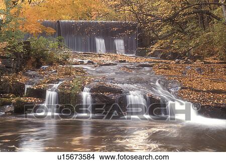 Picture -  waterfall, fall, North Bennington, VT, Vermont, A small waterfall and larger waterfall in the background flow down Paran Creek in North Bennington in autumn.. Fotosearch