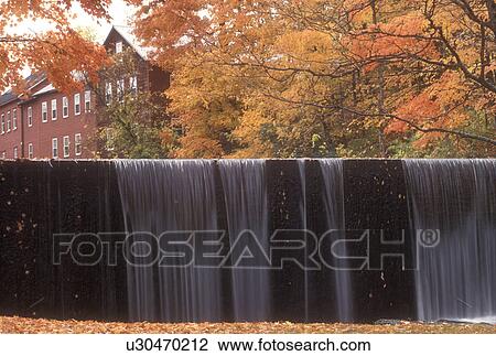 Stock Image -  waterfall, fall, North Bennington, VT, Vermont, A sheet of water cascades over a waterfall on Paran Creek in North Bennington in autumn.. Fotosearch