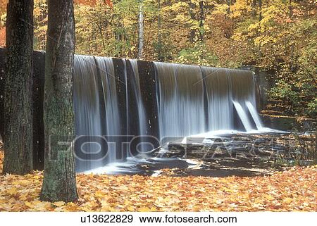 Stock Photo -  waterfall, fall, North Bennington, VT, Vermont, A sheet of water cascades over a waterfall on Paran Creek in North Bennington in autumn.. Fotosearch