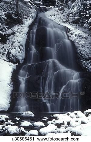 waterfall, river, Green Mountain National Forest, winter scene, snow, Scenic Moss Glen Falls cascades down over snow covered rocks on its way downstream on a wintry day in Granville Gulf Reservation in Addison County in the state of Vermont. View Large Photo Image Stock Image - waterfall, river, Green Mountain National Forest, winter scene, snow, Scenic Moss Glen Falls cascades down over snow covered rocks on its way downstream on a wintry day in Granville Gulf Reservation in Addison County in the state of Vermont. . Fotosearch