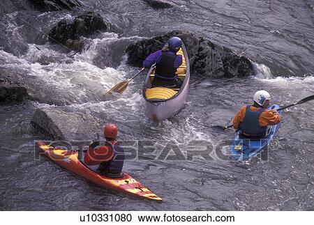 Stock Image -  white water, canoe, kayak, spring, Moretown, VT, Vermont, People canoeing and kayaking on Mad River in the spring in Moretown.. Fotosearch