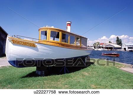 Stock Photo -  wood boat, Clayton, Thousand Islands, New York, NY, Freshwater wooden boat displayed outside the Antique Boat Museum.. Fotosearch