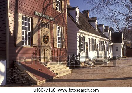 Stock Photo -  wreath, Christmas, Colonial Williamsburg, Virginia, VA, Williamsburg, Christmas wreaths hang on the doors of the village stores in Colonial Williamsburg.. Fotosearch