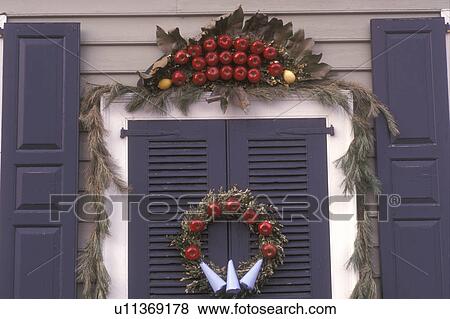 Stock Photo -  wreath, Colonial Williamsburg, Virginia, VA, Williamsburg, A wreath made of greens and apples decorate the door of a home for Christmas in Colonial Williamsburg.. Fotosearch