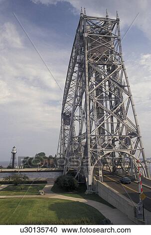 Stock Image -  aerial lift bridge, Duluth, MN, Minnesota, Lake Superior, Canal Park, Aerial Lift Bridge spans the canal entrance to Duluth Harbor in Duluth.. Fotosearch