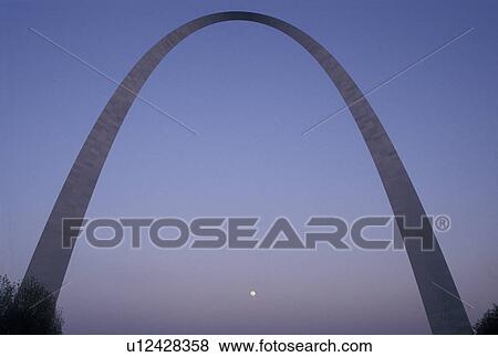 Stock Photo -  arch, Gateway Arch, St. Louis, MO, Missouri, The full moon rises behind The Gateway Arch, Jefferson National Expansion Memorial, in Saint Louis. Gateway to the West.. Fotosearch