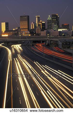 Picture -  Atlanta, GA, skyline, Georgia, Traffic lights streak on I-75/I-85 at sunset and view of the skyline of downtown Atlanta.. Fotosearch